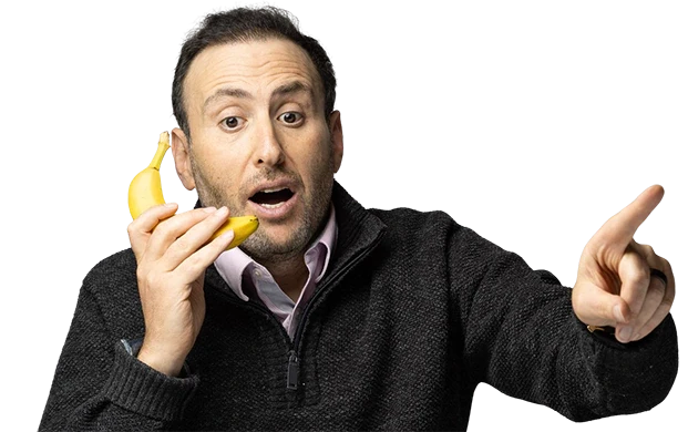 Vitaliy Katsenelson holding a banana like a phone and pointing at the button
